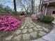 Beautiful stone pathway lined with vibrant pink and red azaleas at 659 Pleasant Hill Nw Rd, Conyers, GA 30012