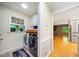 Well-lit laundry room features modern washer/dryer and a window overlooking the yard at 659 Pleasant Hill Nw Rd, Conyers, GA 30012