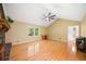 Cozy living room with a vaulted ceiling, hardwood floors, a brick fireplace, and large windows offering natural light at 659 Pleasant Hill Nw Rd, Conyers, GA 30012