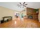 Spacious living room with hardwood floors, a brick fireplace, and large windows, perfect for relaxing or entertaining at 659 Pleasant Hill Nw Rd, Conyers, GA 30012