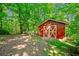Red barn with white trim featuring ample space and is placed in a forest clearing at 659 Pleasant Hill Nw Rd, Conyers, GA 30012