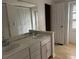 Bathroom featuring a double vanity, a large mirror, and wooden floors at 150 N Pond Ct, Roswell, GA 30076