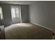 Neutral bedroom featuring plush carpeting, a window with shutter, and ample natural light at 150 N Pond Ct, Roswell, GA 30076