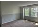 Bright bedroom with carpet flooring and natural light from large windows at 150 N Pond Ct, Roswell, GA 30076