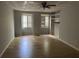 Bright bedroom with hardwood flooring, white paneled ceiling, and built-in shelving providing space at 150 N Pond Ct, Roswell, GA 30076