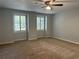 Bright bedroom with plush carpeting, white shutters, and neutral walls creating a serene space at 150 N Pond Ct, Roswell, GA 30076
