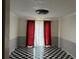 Dining room with unique checkered flooring, neutral walls, and elegant red and white curtains at 150 N Pond Ct, Roswell, GA 30076