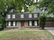 Charming two-story home featuring a red front door, well-maintained landscaping, and a two-car garage at 150 N Pond Ct, Roswell, GA 30076