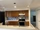 Well-lit kitchen with stainless steel appliances, oak cabinets, and mosaic tile backsplash at 150 N Pond Ct, Roswell, GA 30076