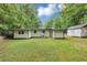Expansive backyard with a well-maintained lawn, mature trees, and a shed at 3458 Cooper St, Lithia Springs, GA 30122