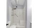 Bathroom featuring a tiled shower with bench, grab bar, and handheld showerhead, providing accessible comfort at 3458 Cooper St, Lithia Springs, GA 30122
