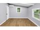 Bright bedroom with wood-look flooring features beamed ceilings and large windows, creating an inviting space at 3458 Cooper St, Lithia Springs, GA 30122