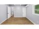 Well-lit bedroom with wood-look flooring and ample space, ideal for versatile living arrangements at 3458 Cooper St, Lithia Springs, GA 30122