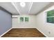 Spacious bedroom features sleek, wood-look flooring, a beamed ceiling, and abundant natural light through bright windows at 3458 Cooper St, Lithia Springs, GA 30122
