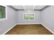 Large bedroom featuring wood-look flooring, base molding, and natural light from large windows at 3458 Cooper St, Lithia Springs, GA 30122