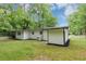 Exterior view of home with white siding, black trim and lush green lawn at 3458 Cooper St, Lithia Springs, GA 30122