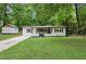 Inviting single-story home with a lush lawn and a detached storage building at 3458 Cooper St, Lithia Springs, GA 30122