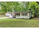 Charming single-story home with fresh exterior paint and a detached storage building at 3458 Cooper St, Lithia Springs, GA 30122