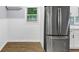 Bright kitchen featuring stainless steel refrigerator and wood-look flooring, perfect for modern living at 3458 Cooper St, Lithia Springs, GA 30122