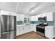 Well-lit kitchen with stainless steel appliances, white cabinets, and modern countertops at 3458 Cooper St, Lithia Springs, GA 30122