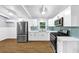 Modern kitchen with stainless steel appliances, bright white cabinets, and stylish backsplash at 3458 Cooper St, Lithia Springs, GA 30122