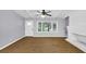 Open living room with hardwood floors, ceiling fan, and a cozy fireplace, perfect for relaxation and entertaining at 3458 Cooper St, Lithia Springs, GA 30122