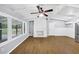 Spacious living room featuring hardwood floors, white brick fireplace, and windows overlooking the front yard at 3458 Cooper St, Lithia Springs, GA 30122