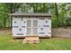 Exterior view of a shed with a wood pallet porch and Everbilt sheeting in a grassy back yard at 3458 Cooper St, Lithia Springs, GA 30122