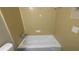 Bathroom featuring a tub with tiled walls and a toilet at 1349 Cedar Heights Dr, Stone Mountain, GA 30083