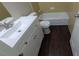 Bathroom featuring a white vanity with dark wood-look flooring and a tub at 1349 Cedar Heights Dr, Stone Mountain, GA 30083