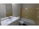 Bathroom featuring a vanity with dark wood-look flooring and a tub with tiled walls at 1349 Cedar Heights Dr, Stone Mountain, GA 30083
