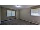 Standard bedroom featuring neutral colors, plush carpet, and two windows at 1349 Cedar Heights Dr, Stone Mountain, GA 30083