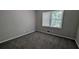 A quiet bedroom with plush carpet and a large window for natural light at 1349 Cedar Heights Dr, Stone Mountain, GA 30083
