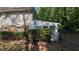 Home's exterior featuring a sunroom addition and mature landscaping at 1349 Cedar Heights Dr, Stone Mountain, GA 30083