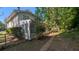Back of home with sunroom, mature trees and chainlink fence at 1349 Cedar Heights Dr, Stone Mountain, GA 30083
