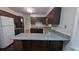 A full kitchen view showing lots of counter space, wooden cabinets, and wood flooring at 1349 Cedar Heights Dr, Stone Mountain, GA 30083