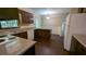 View of kitchen with wood cabinets, laminate countertops and white appliances at 1349 Cedar Heights Dr, Stone Mountain, GA 30083