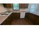 Kitchen with wood cabinets, laminate countertops, white appliances, and updated laminate flooring at 1349 Cedar Heights Dr, Stone Mountain, GA 30083