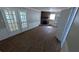 View of a living room with a brick fireplace, built in shelves, and hardwood flooring at 1349 Cedar Heights Dr, Stone Mountain, GA 30083