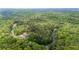 Expansive aerial view of a secluded home surrounded by lush greenery and a winding driveway at 16 Mountain Creek Ne Trl, Fairmount, GA 30139