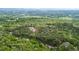Aerial view of 5 acre property featuring mature trees, lush green space, and winding driveway at 16 Mountain Creek Ne Trl, Fairmount, GA 30139