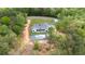 Aerial view of modern home with swimming pool and black fence surrounded by mature trees at 16 Mountain Creek Ne Trl, Fairmount, GA 30139