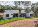 Spacious backyard with a covered porch featuring a stone fireplace and a well-maintained lawn at 16 Mountain Creek Ne Trl, Fairmount, GA 30139