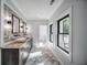Bathroom with a double sink vanity, stylish wall decor, tile floors, and natural lighting at 16 Mountain Creek Ne Trl, Fairmount, GA 30139