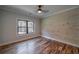 Bedroom featuring hardwood floors, a window and a wood paneled wall at 16 Mountain Creek Ne Trl, Fairmount, GA 30139