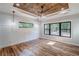 Bright bedroom with a decorative wood ceiling, fan, natural lighting, and hardwood floors at 16 Mountain Creek Ne Trl, Fairmount, GA 30139