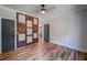 Stylish bedroom boasts beautiful wood floors, decorative accent wall and trim, and neutral walls at 16 Mountain Creek Ne Trl, Fairmount, GA 30139
