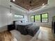 Serene bedroom with wood ceiling, large windows and natural light creating a relaxing atmosphere at 16 Mountain Creek Ne Trl, Fairmount, GA 30139