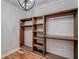 Walk in closet with wooden shelving and rod system and hardwood floors at 16 Mountain Creek Ne Trl, Fairmount, GA 30139