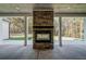 Covered patio area with stone fireplace feature and outdoor seating, perfect for entertaining at 16 Mountain Creek Ne Trl, Fairmount, GA 30139